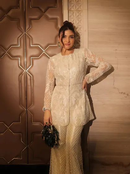 A full-length portrait showcasing this stunning all-white ensemble and the flawless makeup that completes the look.