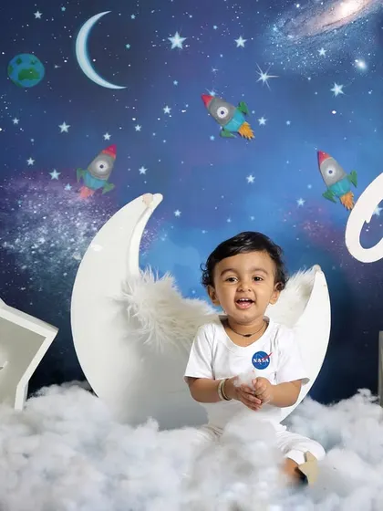 A little astronaut ready for takeoff. This space-themed shoot is perfect for adventurous little ones, complete with a moon, stars, and rockets.