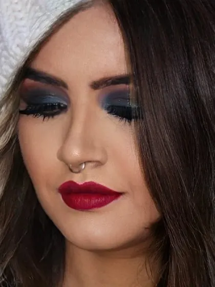 A close up of a classic smokey eye, perfect for a glamorous evening out. I used deep blue and black shades blended seamlessly, paired with a matte red lip for a timeless and sophisticated party makeup look.