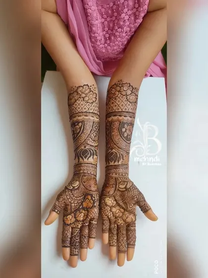 An elegant and symmetrical design with delicate floral work on the palms and fingers. The arms feature a beautiful blend of traditional motifs and patterns.