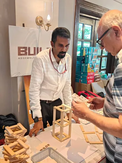 Our facilitator engages with a participant, explaining a building technique. We are always on hand to offer guidance, introduce new concepts, and ensure the experience is both fun and educational for everyone.