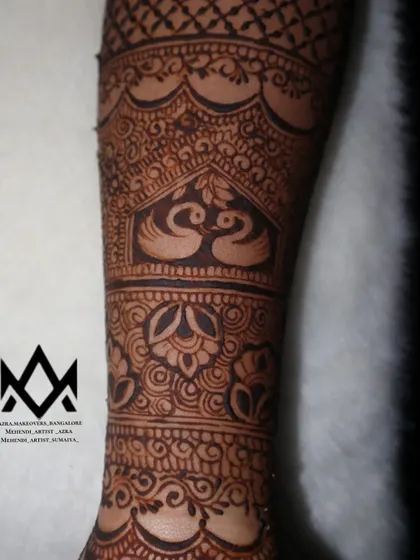 A close up of a swan motif within a bridal arm band, symbolizing grace and love.
