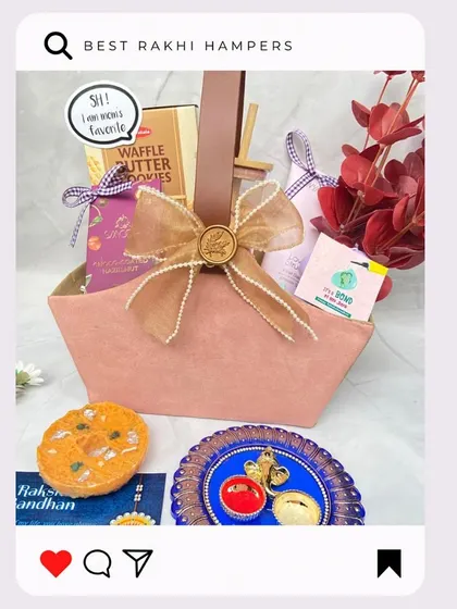 A lovely pink basket hamper for Rakhi, filled with cookies and other treats, and tied with a beautiful pearl-studded bow.