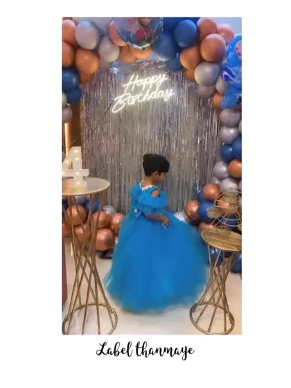 The birthday girl at her party. The full blue tulle skirt on her princess gown looks so magical.