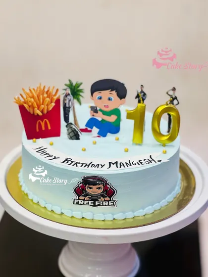 A cake for a Free Fire gamer. This design includes elements from the game, along with some of the player's other favorites like McDonald's fries.