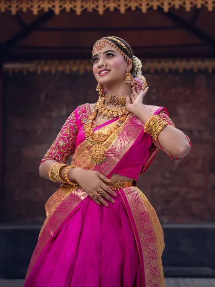 A full-view shot that captures the grace of the half-saree and the complete set of matching gold-plated jewellery.