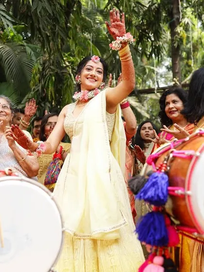 The bride's solo dance moment with the dhol players. We make sure to capture her joy and energy during the Haldi entrance.