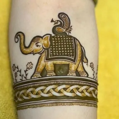 A creative twist on the classic elephant motif, with a peacock riding on top. This kind of custom figure work adds a playful and unique element to your mehandi.