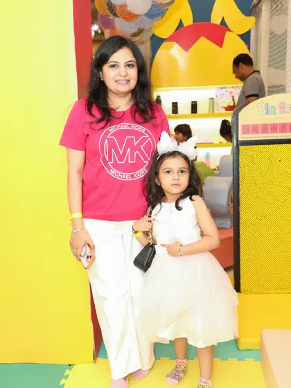 A mother and daughter pose for a sweet photo in the play area.
