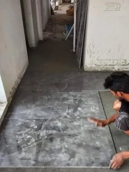 A tiler at work, ensuring each tile is perfectly level. We manage our own professional team to ensure quality control at every stage of the project.