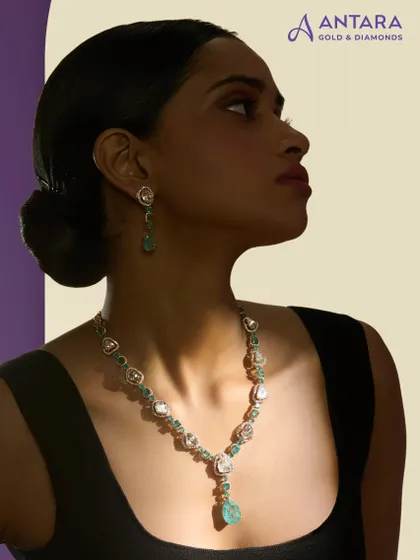 Here is a cascade of uncut polkis and green tourmaline accents, handcrafted in 14 kt gold. The necklace flows into a faceted drop, designed so that every detail shines with an inner light.