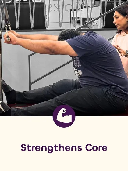 A strong core is the foundation of an injury-free body. Here, an instructor guides a client through a core-strengthening exercise, ensuring proper form to maximize benefits and prevent strain.
