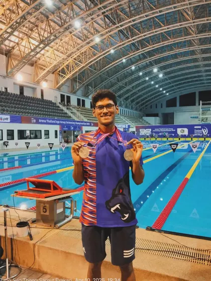Pavan Dhananjaya clinching two silver medals at the Thailand Age Group Swimming Championship.