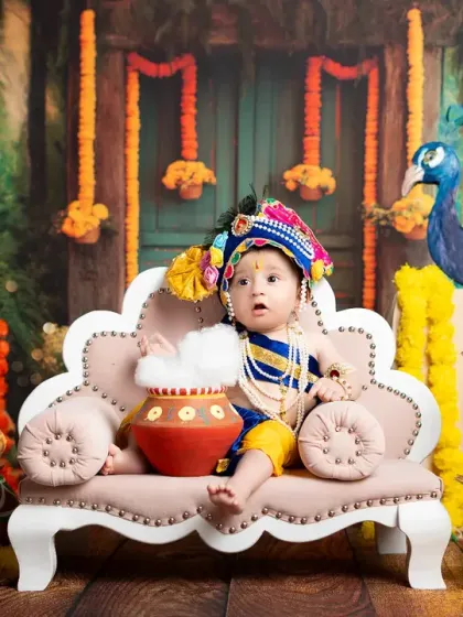 This little Krishna is ready for his close-up, holding a pot full of "butter." The lighting and composition are carefully planned to create a divine and beautiful image.
