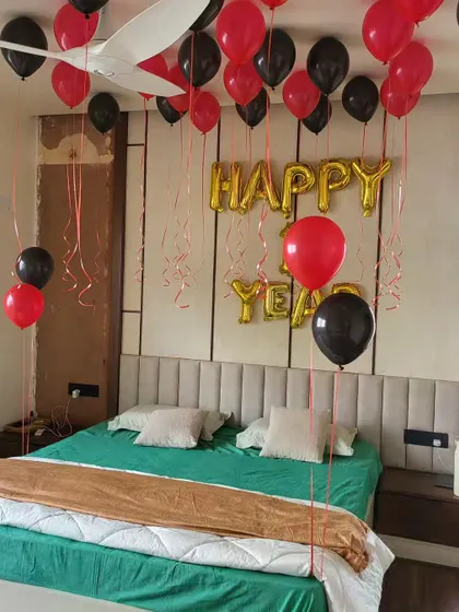 Red and black helium balloons used for a Happy New Year room decoration.