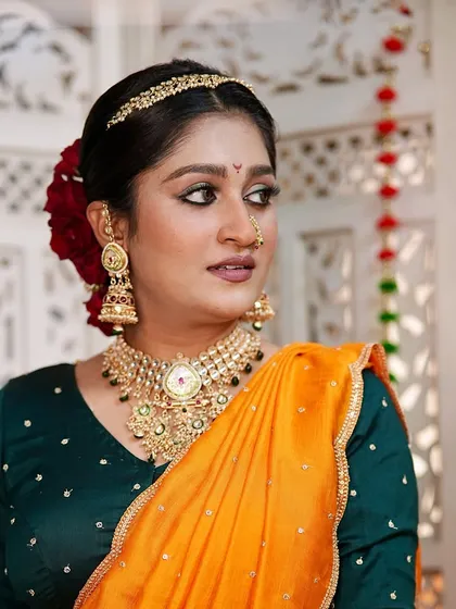 A three-quarter profile showcasing the clean lines of the makeup and the elegant hairstyle. This look is perfect for a bride who wants a unique and memorable style.