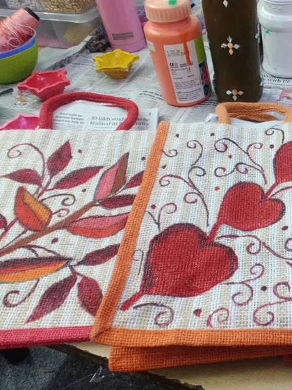 Two different heart and leaf motifs painted on small jute bags. The possibilities are endless with fabric painting.