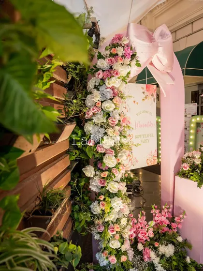 A side angle of the floral entrance arch, showing how it beautifully frames the walkway into the party.