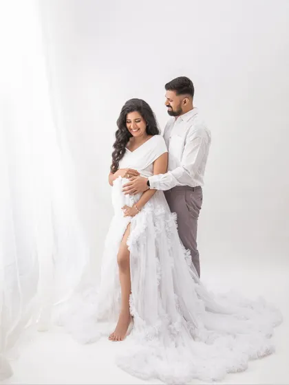 Standing by the soft light of the window, this portrait has a beautiful, airy feel. A timeless image of a couple waiting for their baby.