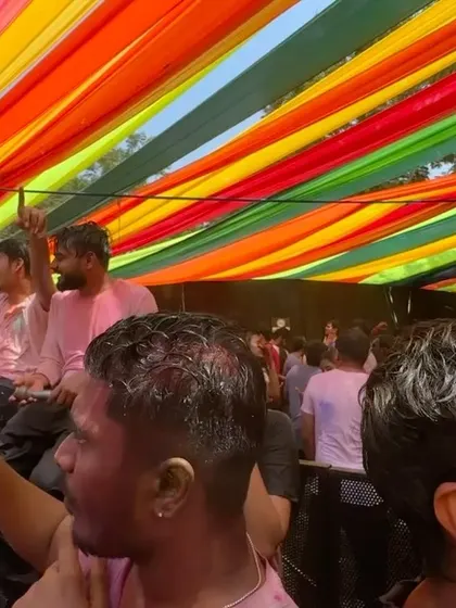 Looking up at the rainbow of fabrics at a festival. This kind of large-scale, colorful decor is a huge part of creating an event's atmosphere, and it's a service I offer alongside my interactive installations.