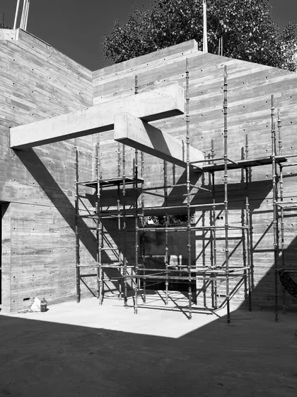 The same cantilevered beam element seen from a wider angle, with scaffolding still in place. This shows how such a complex form is supported during the concrete curing process.