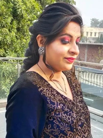A soft glam makeup look with a focus on a shimmering pink eyeshadow and a classic red lip. The braided hairstyle is perfect for keeping hair manageable during a long event.