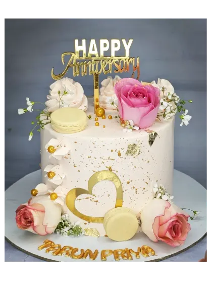 A stunning anniversary cake decorated with fresh roses, macarons, and gold leaf. This fresh pineapple cake is both elegant and delicious.