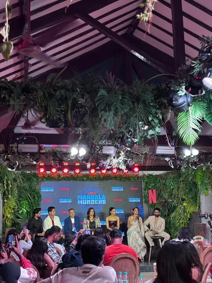A wide shot of the intimate press event for 'Mandala Murders'. We manage events of all scales, from massive auditoriums to smaller, themed venues.