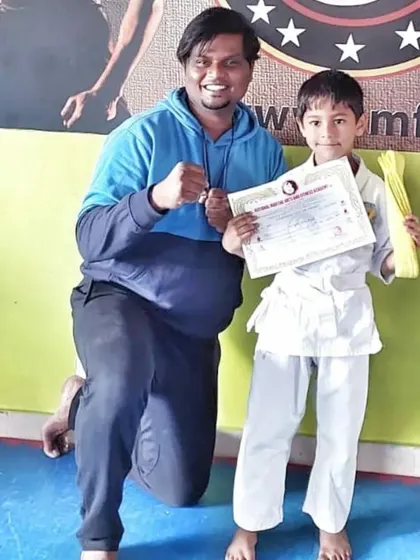 Another proud student receives his yellow belt, the first of many accomplishments in his martial arts journey.