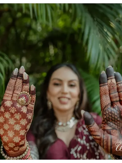 A close-up of the bride's intricate Mehendi design, a beautiful blend of tradition and personal storytelling that we coordinate with talented henna artists.