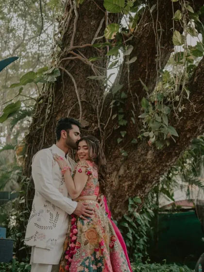 A romantic portrait of the couple under a large tree during their Haldi festivities.