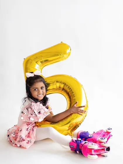 This skater girl is rolling into her fifth birthday in style! Milestone photoshoots are a great way to capture your child's growing personality and interests, from their shy first year to their confident fifth.