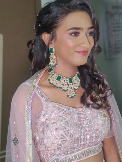 The pastel pink lehenga paired with emerald jewellery is a beautiful and modern combination.