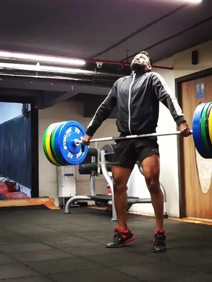 It never gets easier, you just get stronger. This photo captures the moment of peak exertion during a clean, right after the explosive pull from the floor. This is where strength is built.