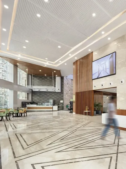Hospital lobbies are the crucial first impression and a central hub of activity. Our design for this reception area uses double-height ceilings, natural materials, and clear circulation paths to manage high footfall efficiently, creating a grand yet welcoming atmosphere that reduces stress and aids wayfinding.