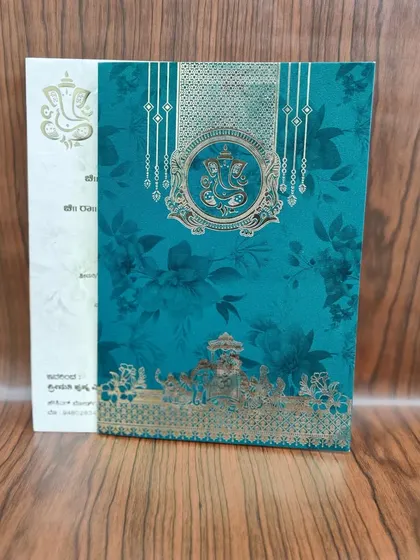 Another variation of the teal invitation, this one featuring a traditional South Indian temple motif at the bottom.