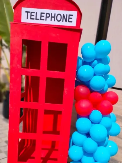 A prop of a red telephone booth, used as part of the London section of the travel theme.