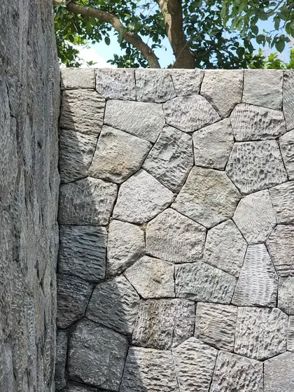 The texture of a random rubble stone wall at Villa 16. Using local materials and traditional construction techniques grounds the architecture in its place and gives it a timeless quality.