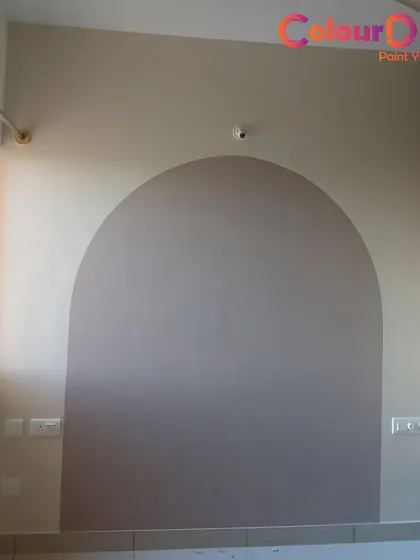 A simple yet effective painted arch design. This technique is a modern way to define a space or create a faux headboard, adding architectural interest with just paint.