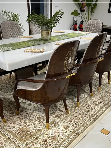 Detail is everything. These custom dining chairs feature intricate woodwork and gold accents, adding a touch of royalty and elegance to the dining experience at the guest house.