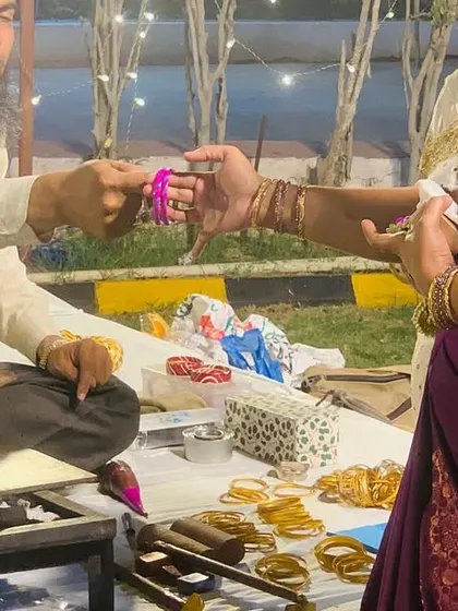 A guest gets a custom bangle made at our live bangle-making station. This is a unique and popular addition to Mehendi functions, half-saree ceremonies, and weddings.