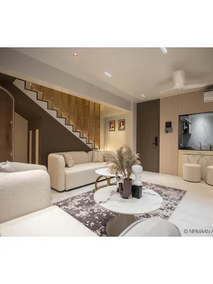 This is the heart of our Duplex Project, a contemporary living room designed for comfort and quiet luxury. We focused on a warm, neutral palette, plush textures, and a statement staircase with integrated lighting to create an inviting and sophisticated atmosphere.