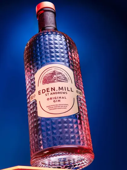 For this Eden Mill gin bottle, I used dramatic red and blue lighting to highlight the textured glass. This technique creates a visually striking image that emphasizes the bottle's unique design.