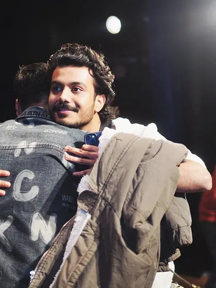 A warm hug with one of the judges. These are the real, heartfelt moments behind the scenes of a big festival.
