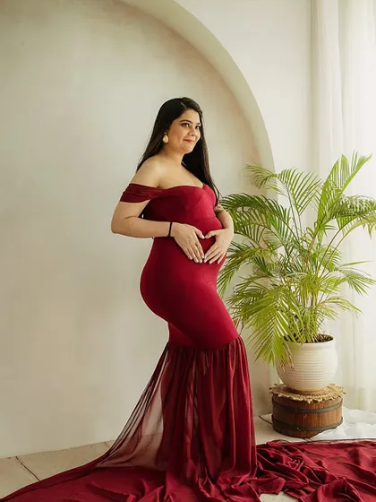 A heart for her baby. This sweet gesture of making a heart shape with her hands on the bump is a universal symbol of a mother's love.