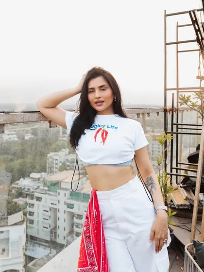 Posing on the rooftop before my sundowner set. The "Spicy Life" tee perfectly captures the energy I bring to my music.