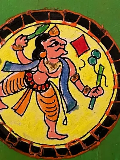 A hand-painted Ganjifa art coaster depicting a dynamic folk figure. Learning to create these small, detailed pieces is a great exercise in precision and storytelling.