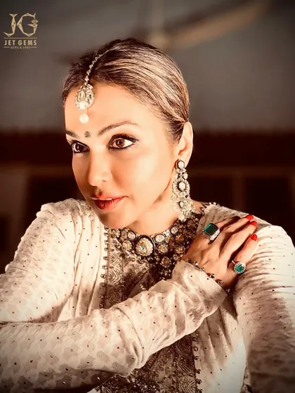 A profile of pure radiance. Isha Koppikar wears our elaborate Polki necklace and earring set, showcasing the grandeur of traditional Indian jewellery.