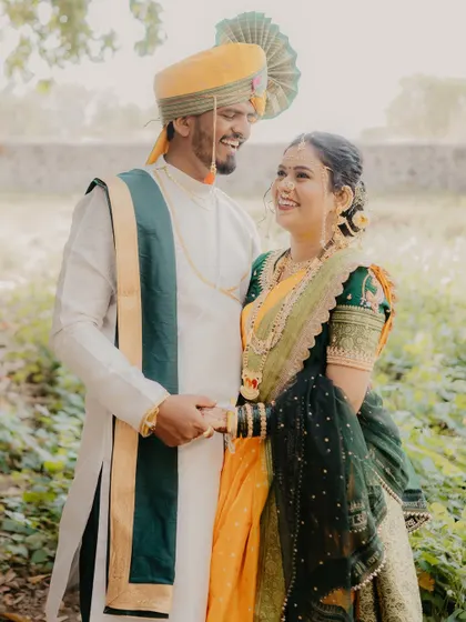 A happy, relaxed portrait of the couple holding hands and smiling. This image captures the easy, joyful nature of their relationship during their outdoor shoot.