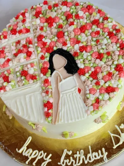 Such a cutesy cake! This design features a hand-piped illustration of a girl in a field of flowers, all done with buttercream.